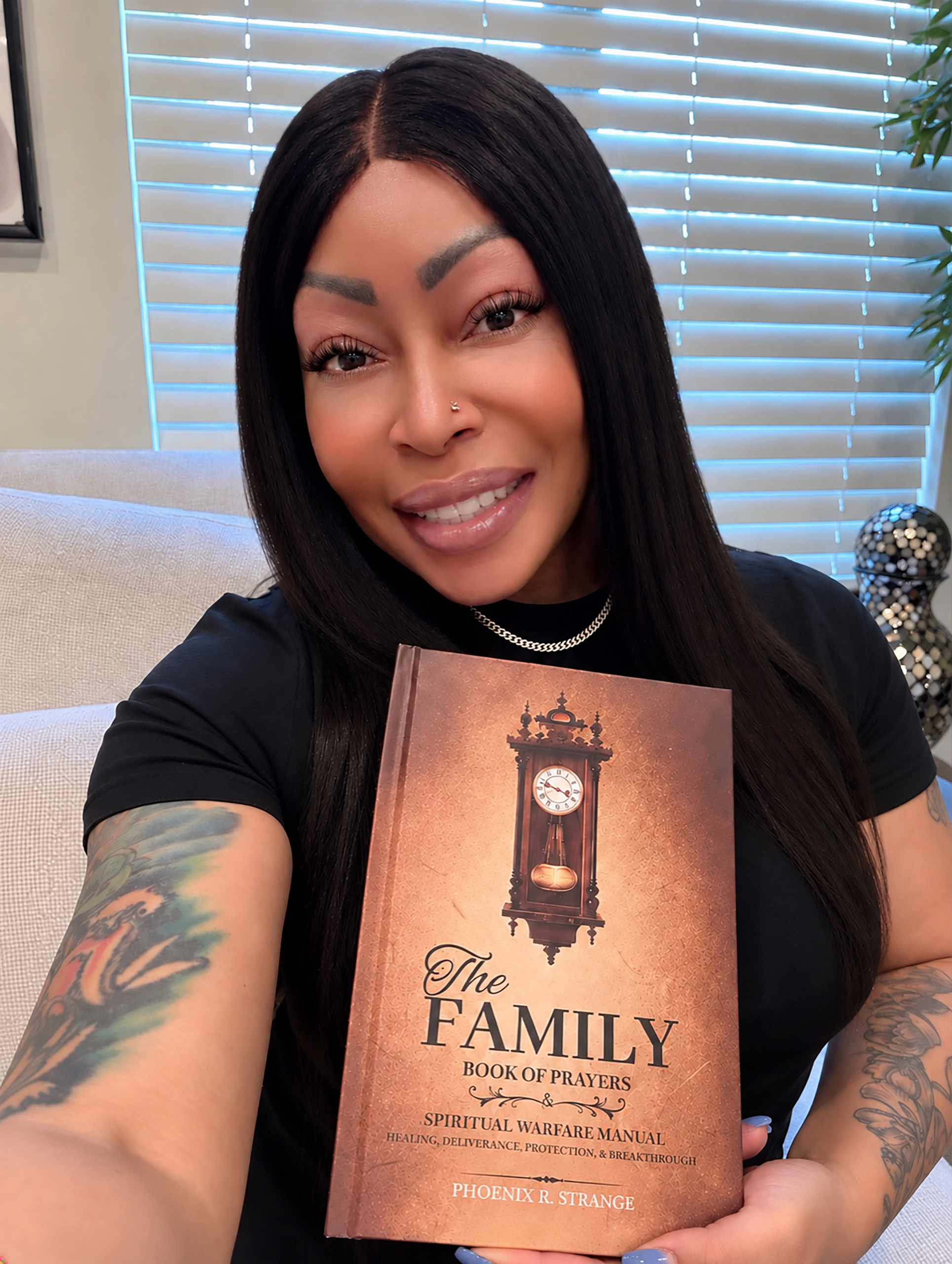 Author Phoenix R. Strange holding The Family Book of Prayers